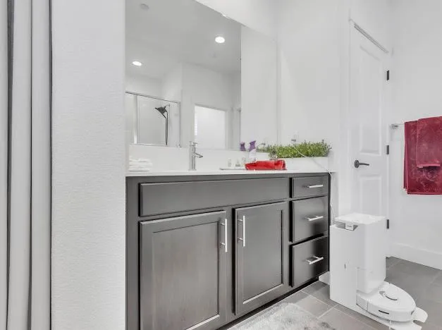 a bathroom with a sink vanity and mirror