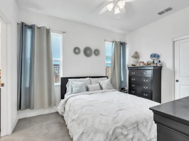 a bedroom with a large bed and a dresser