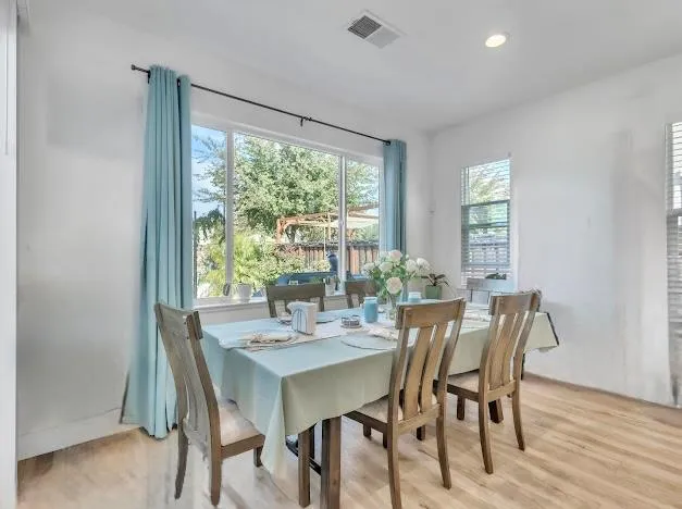 a view of a dining room with furniture and window