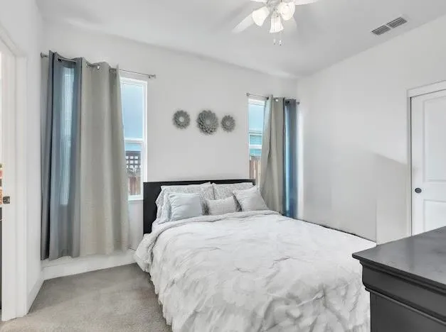 a bedroom with a large bed and a chandelier