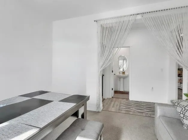 a living room with a bed and a table