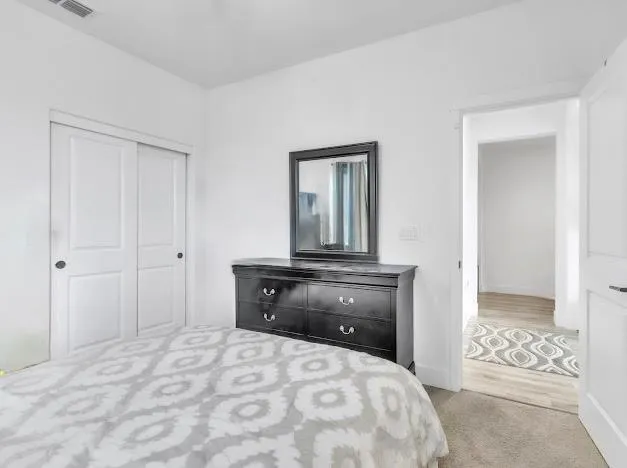 a bedroom with a bed and a dresser