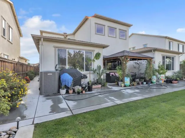 a view of a house with backyard sitting area and garden