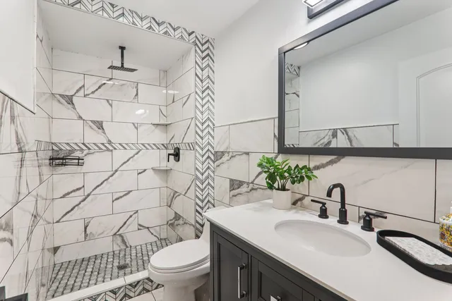 a bathroom with a sink toilet and shower