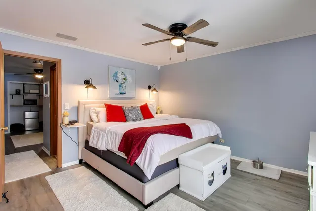 a bedroom with a bed and a chandelier