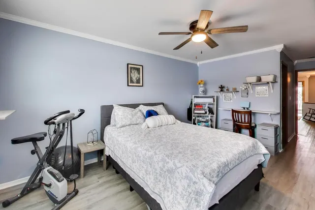 a bedroom with bed and a chandelier