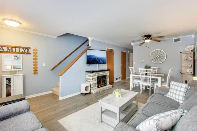 a living room with furniture and a clock