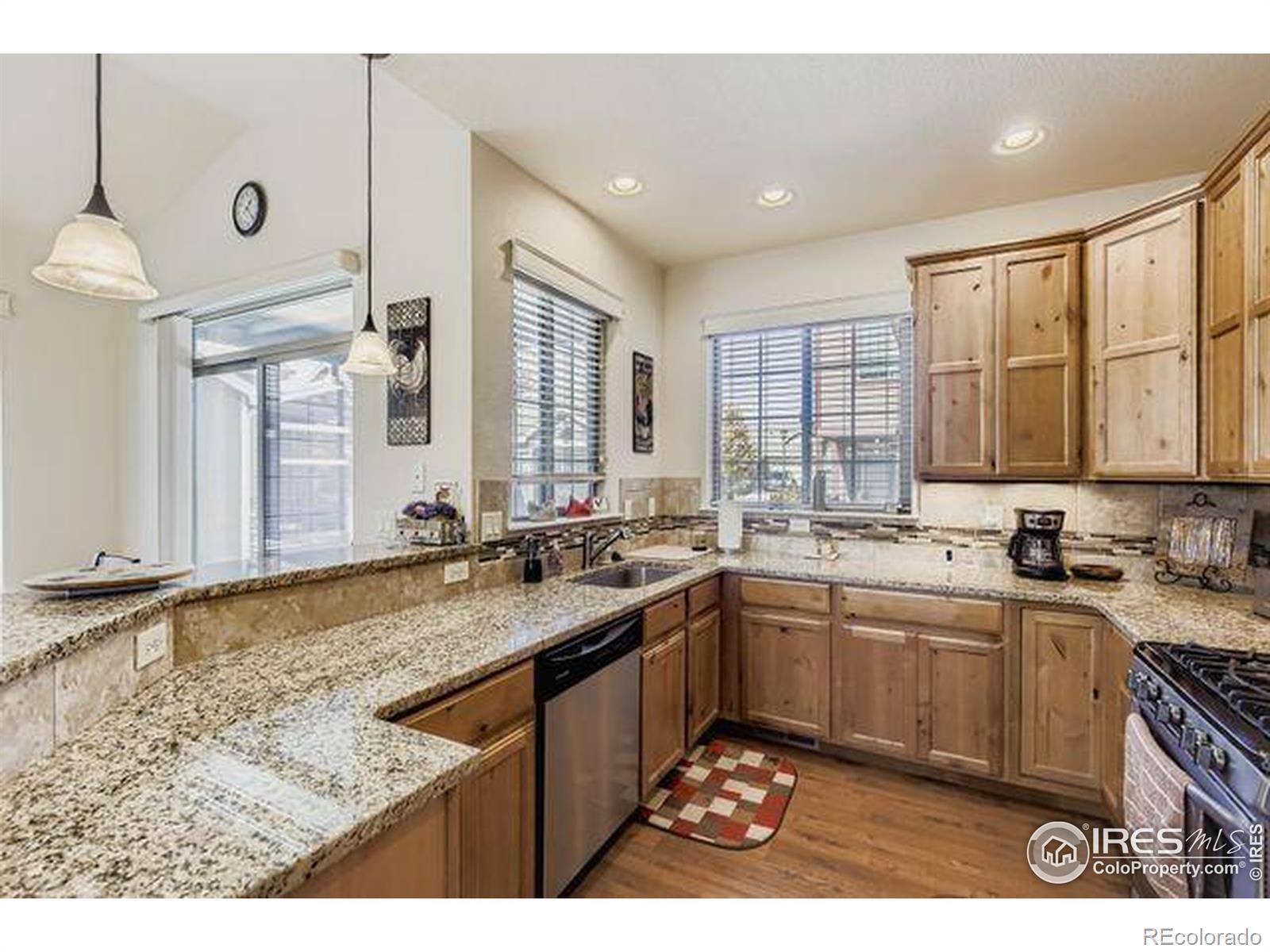 3453 Rhea Drive Loveland, CO 80537 - Photo 11 of 33 a kitchen with a sink stove and cabinets