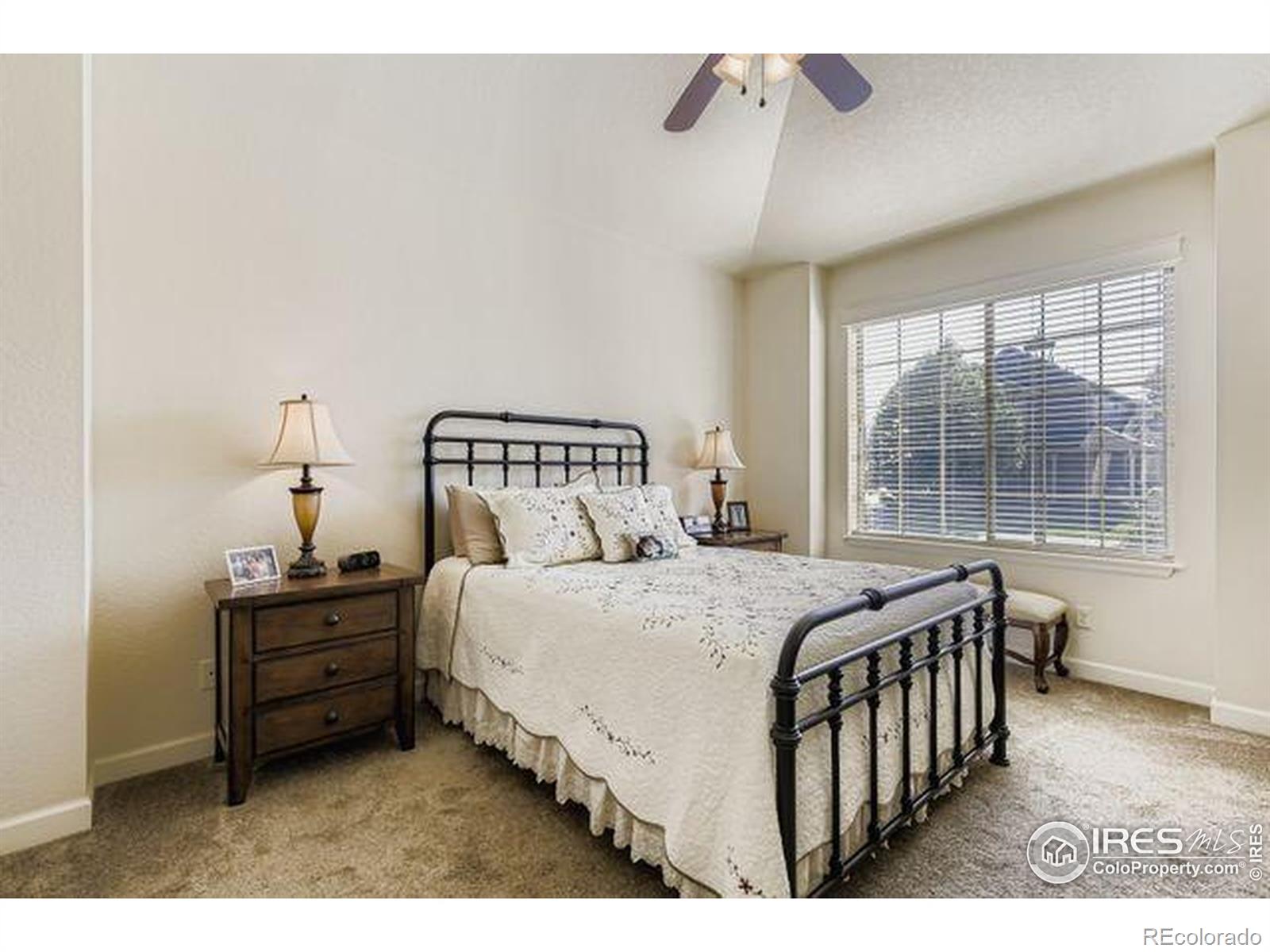 3453 Rhea Drive Loveland, CO 80537 - Photo 15 of 33 a bedroom with a bed a window and walk in closet