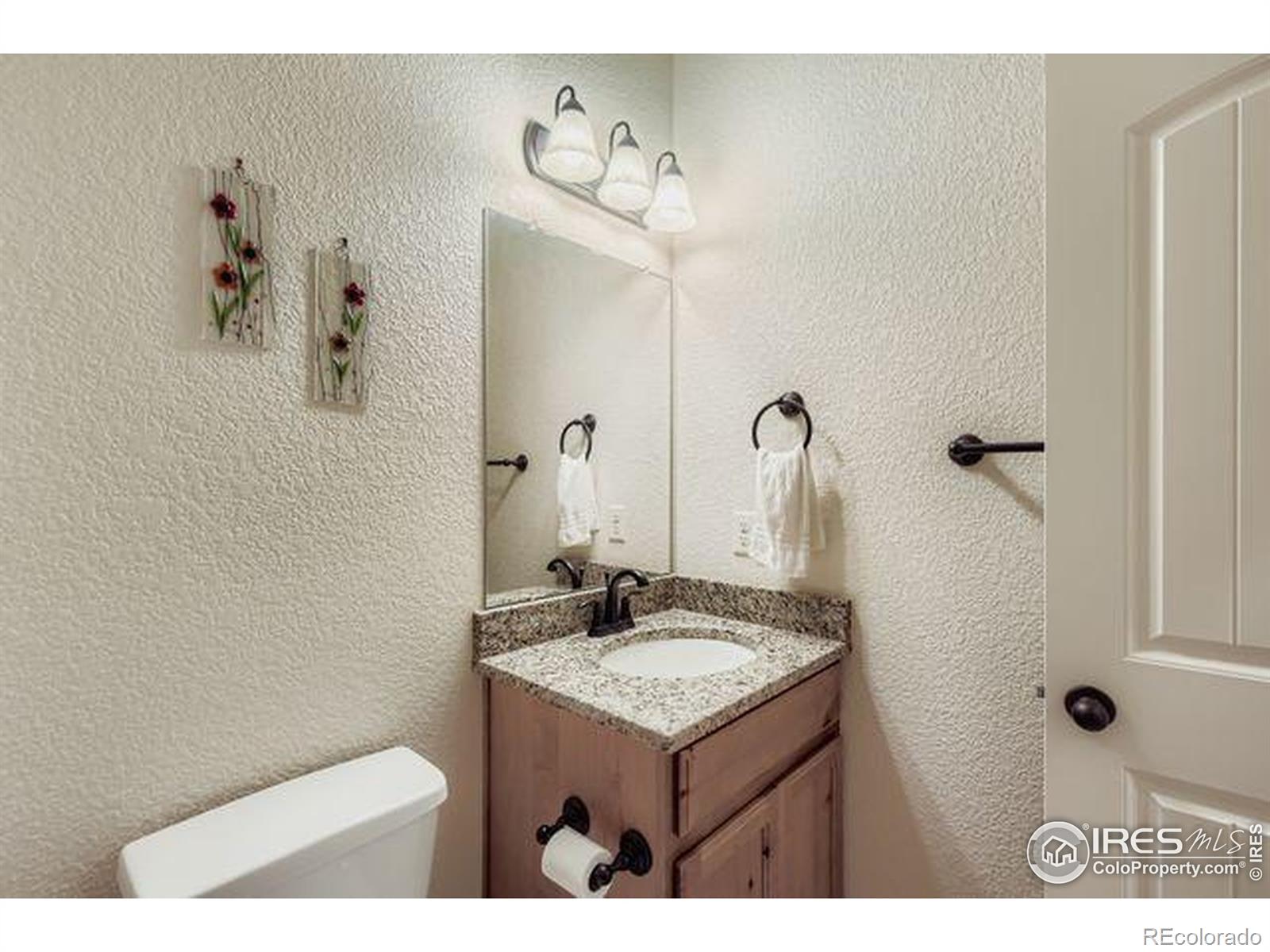 3453 Rhea Drive Loveland, CO 80537 - Photo 21 of 33 a bathroom with a sink and mirror
