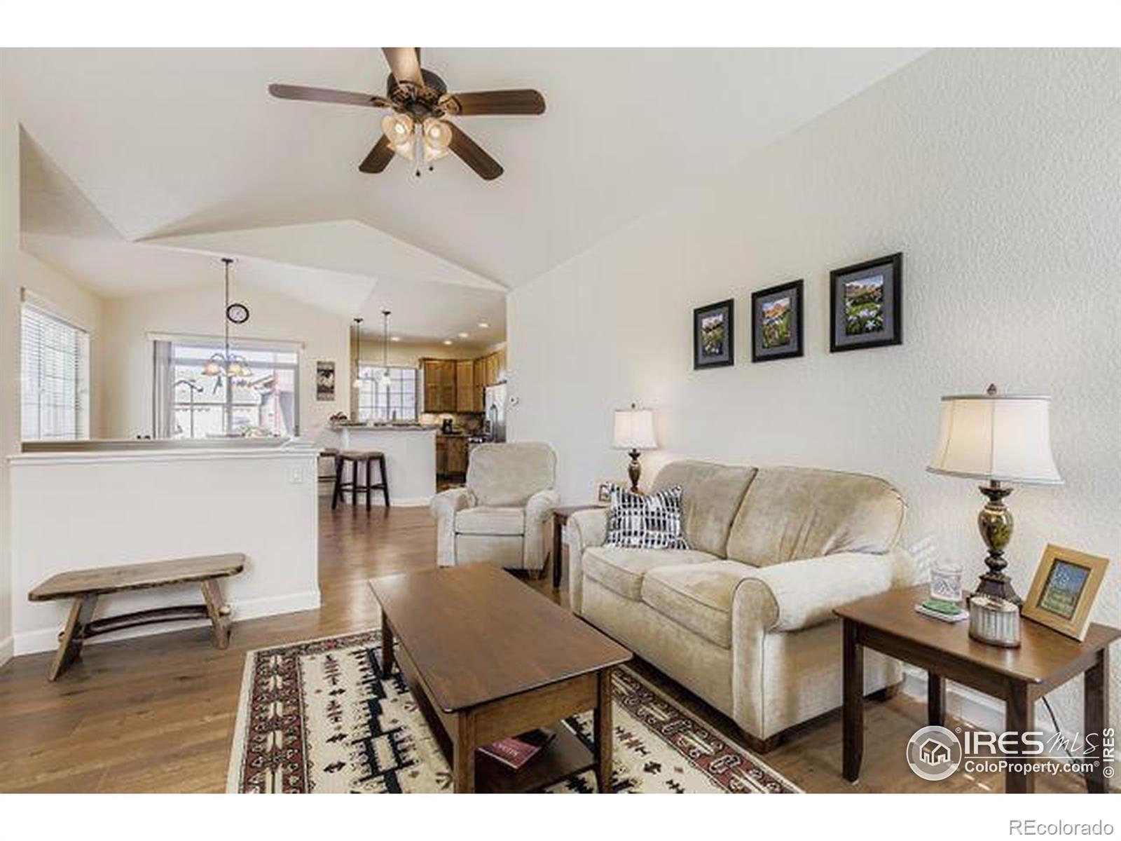 3453 Rhea Drive Loveland, CO 80537 - Photo 7 of 33 a living room with furniture and a wooden floor