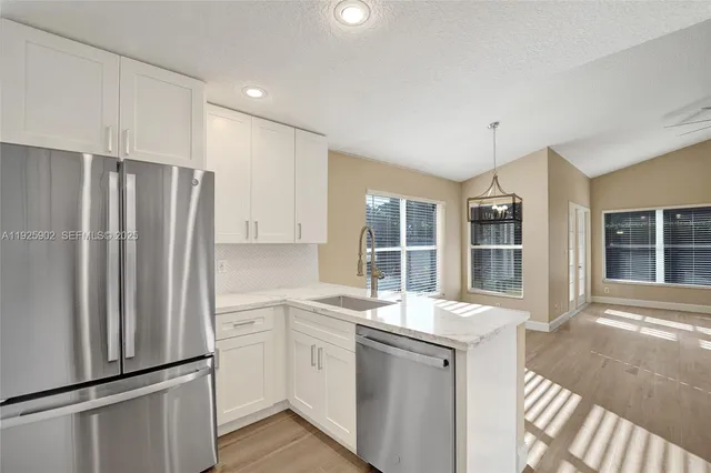 a kitchen that has a refrigerator and a sink