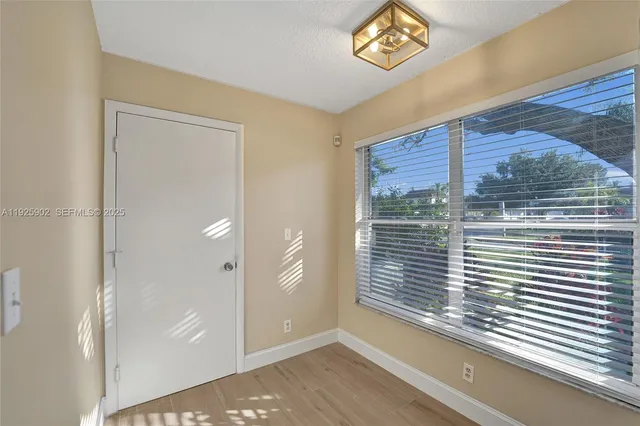 a view of a door and wooden floor