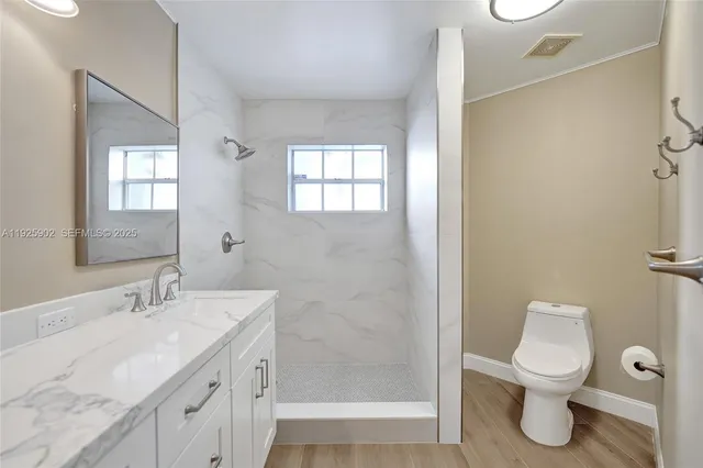 a bathroom with a toilet sink and shower