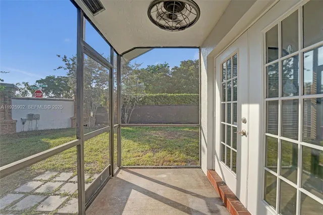 a view of a porch with a floor to ceiling window next to a yard