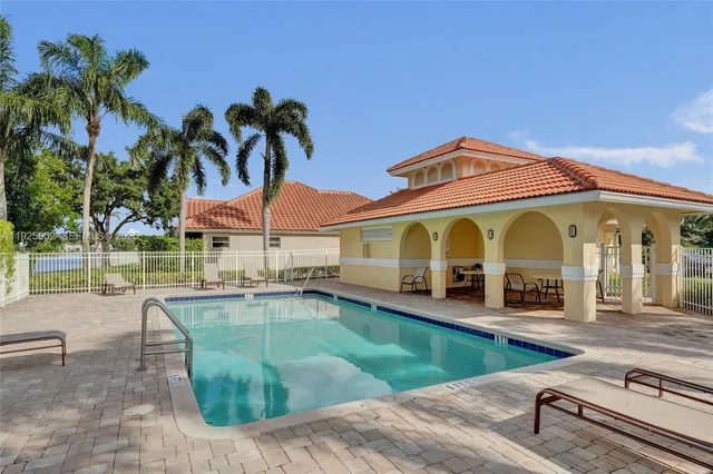 a view of a house with swimming pool and a porch