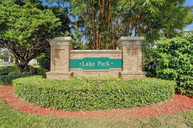 a sign that is sitting in front of flowers