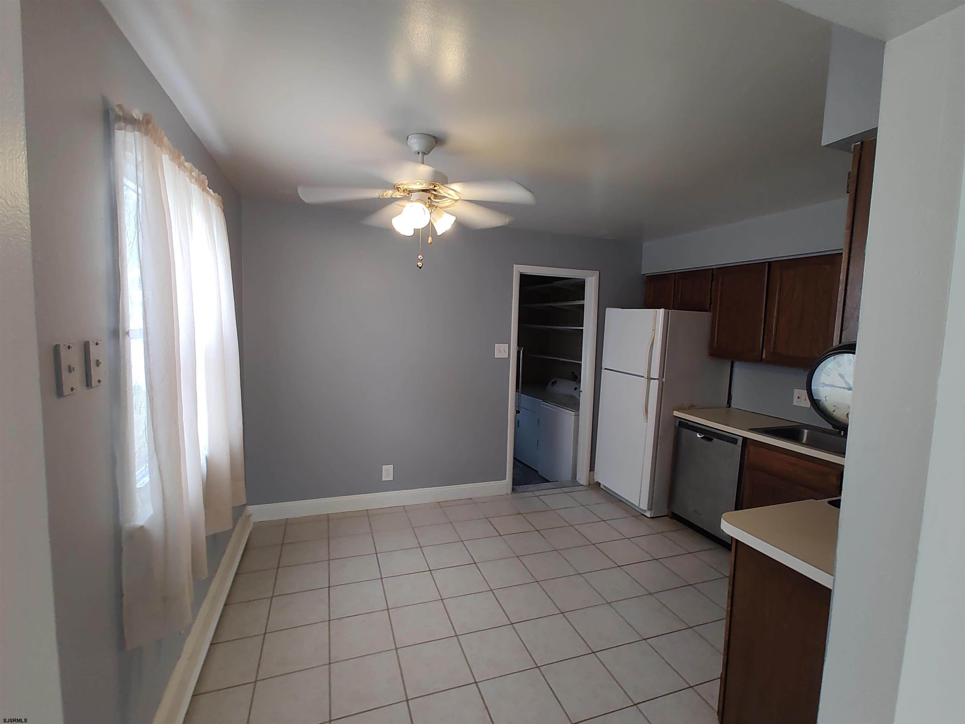323 41st Street South, Unit 1 Brigantine, NJ 08203 - Photo 4 of 11 a view of a kitchen with a stove fridge and wooden floor