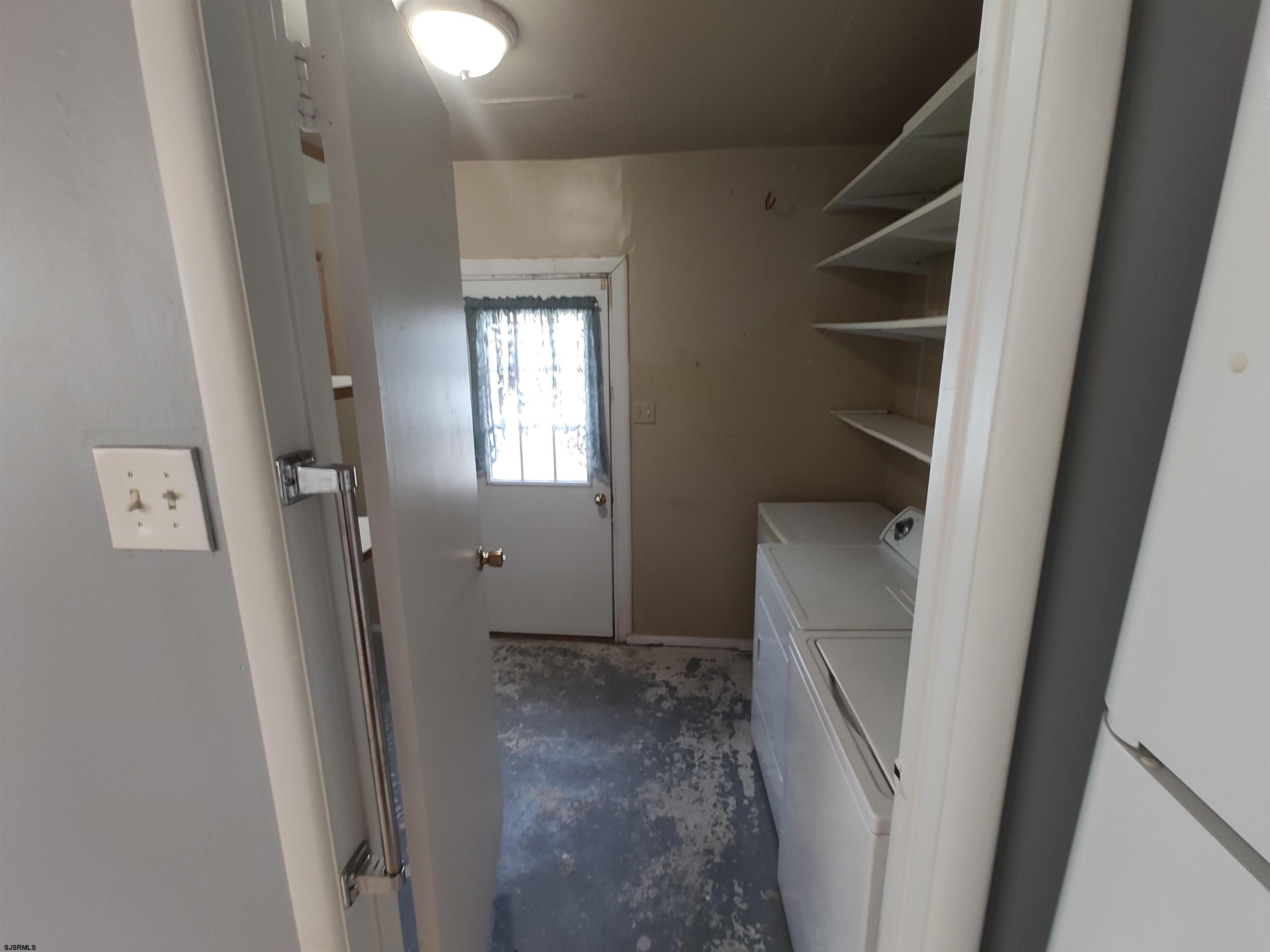 323 41st Street South, Unit 1 Brigantine, NJ 08203 - Photo 6 of 11 a view of an empty room with wooden floor and a window