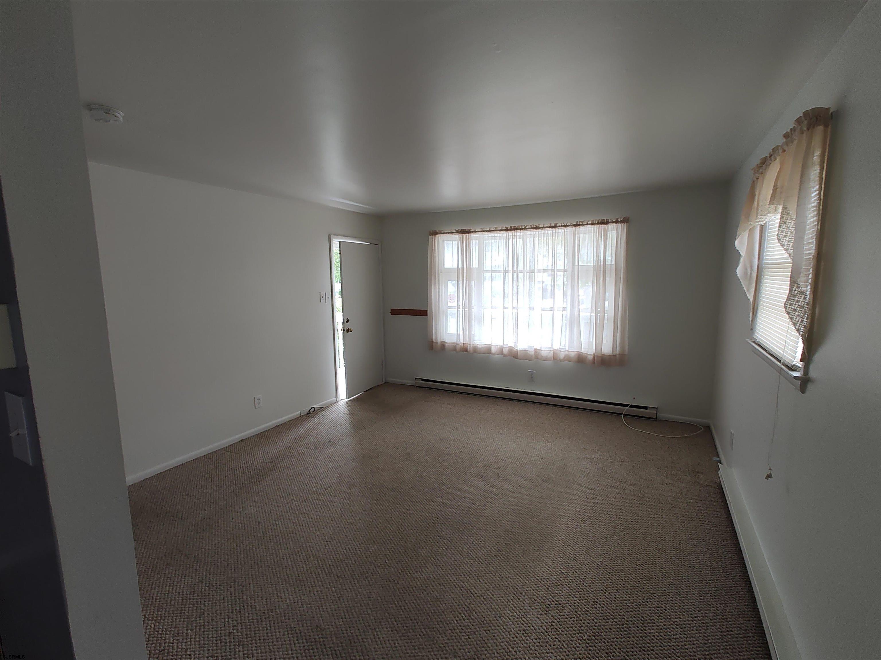 323 41st Street South, Unit 1 Brigantine, NJ 08203 - Photo 7 of 11 an empty room with windows