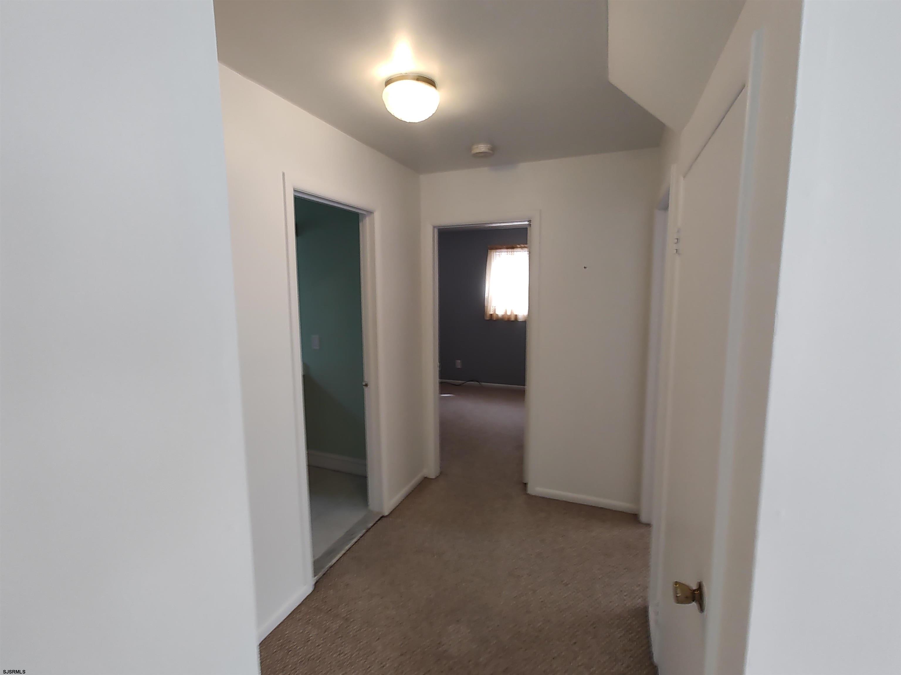 323 41st Street South, Unit 1 Brigantine, NJ 08203 - Photo 8 of 11 an empty room with closet and mirror