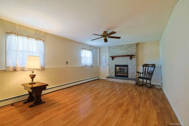 a view of an empty room with a fireplace and a window