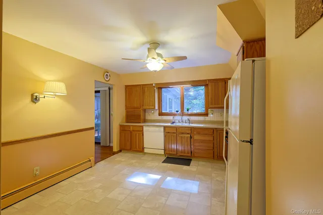 a kitchen with refrigerator and cabinets