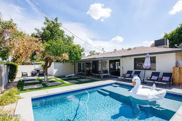 a swimming pool view with a seating space and furniture