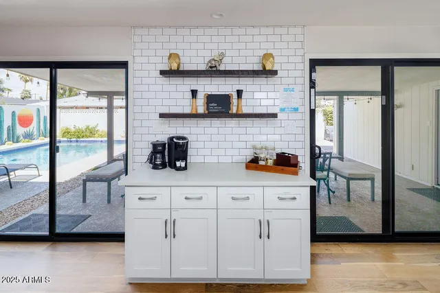 a kitchen with a white cabinets and outdoor space