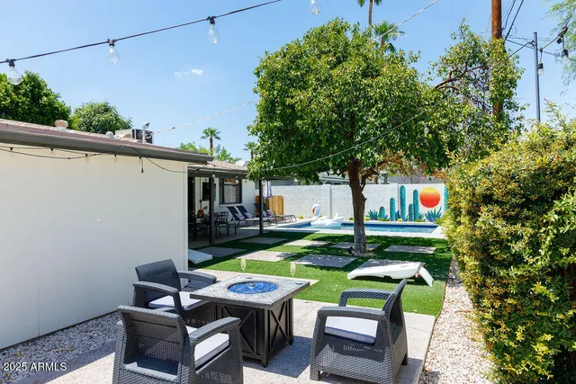 a view of a patio with table and chairs and potted plants