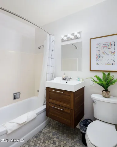 a bathroom with a sink mirror vanity and toilet