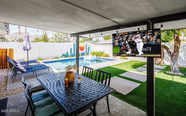 a view of an outdoor dining space with a table and chairs