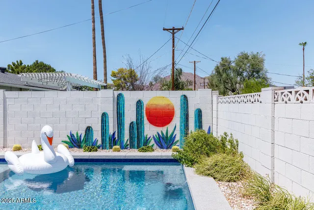 a front view of a house with an outdoor space and seating area