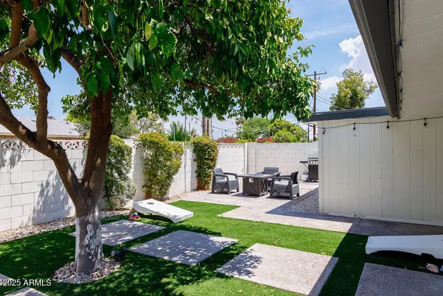 a view of a backyard with sitting area