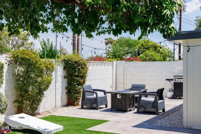 a backyard of a house with table and chairs