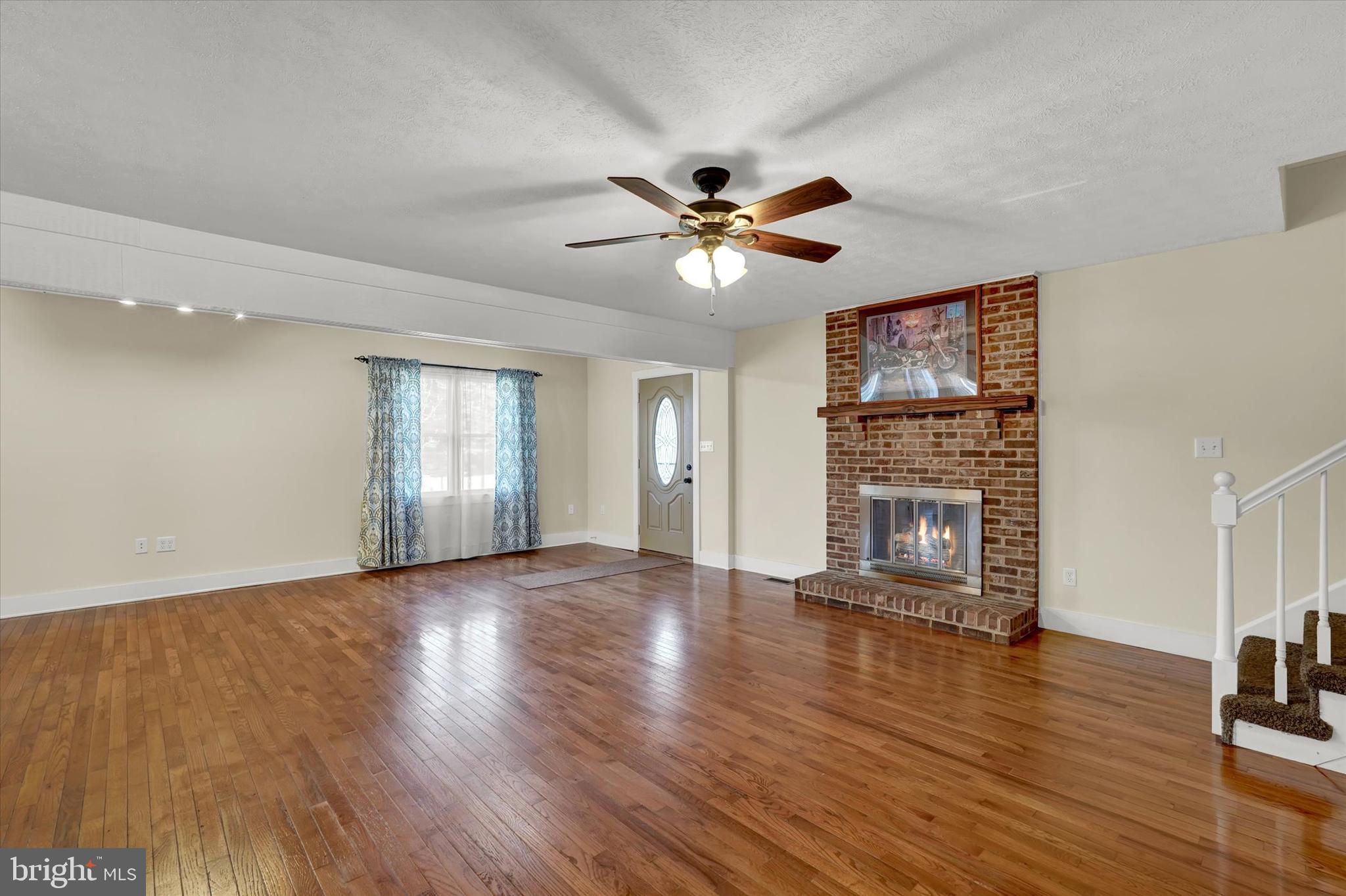 13300 Trout School Road Felton, PA 17322 - Photo 8 of 33 Living area with hard Wood Floors, wood fireplace