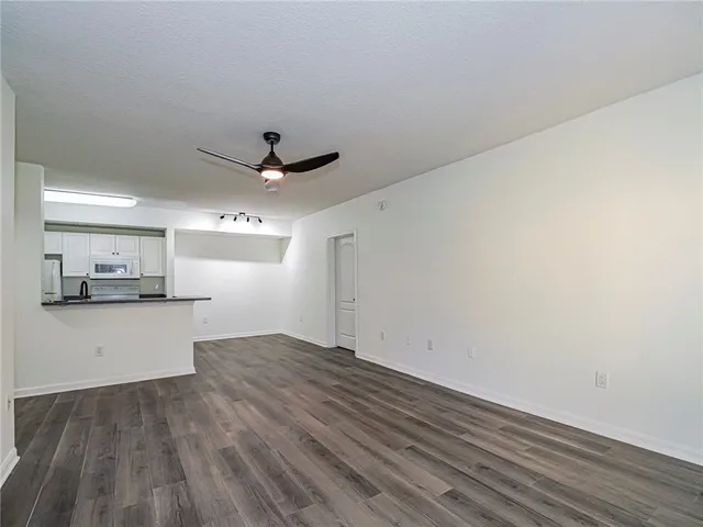 a view of a kitchen with a sink and a refrigerator