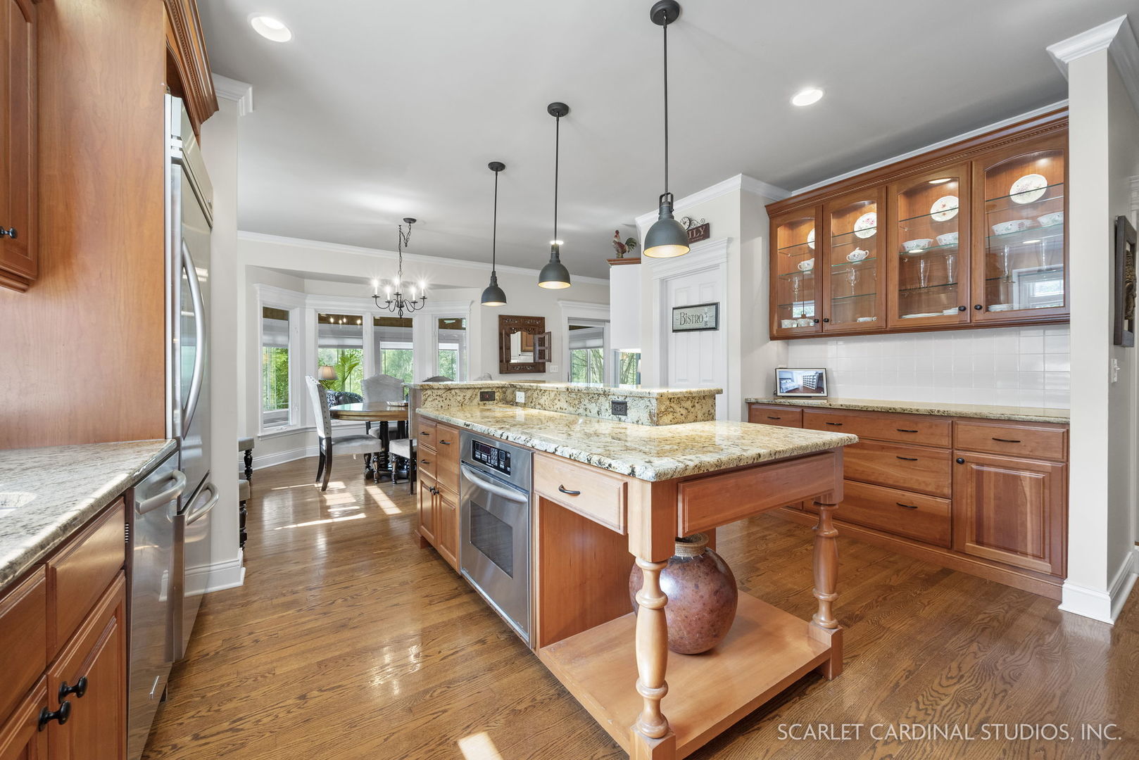 1736 Robert Lane Naperville, IL 60564 - Photo 18 of 82 a kitchen with kitchen island a stove a sink a oven and a dining table with wooden floor