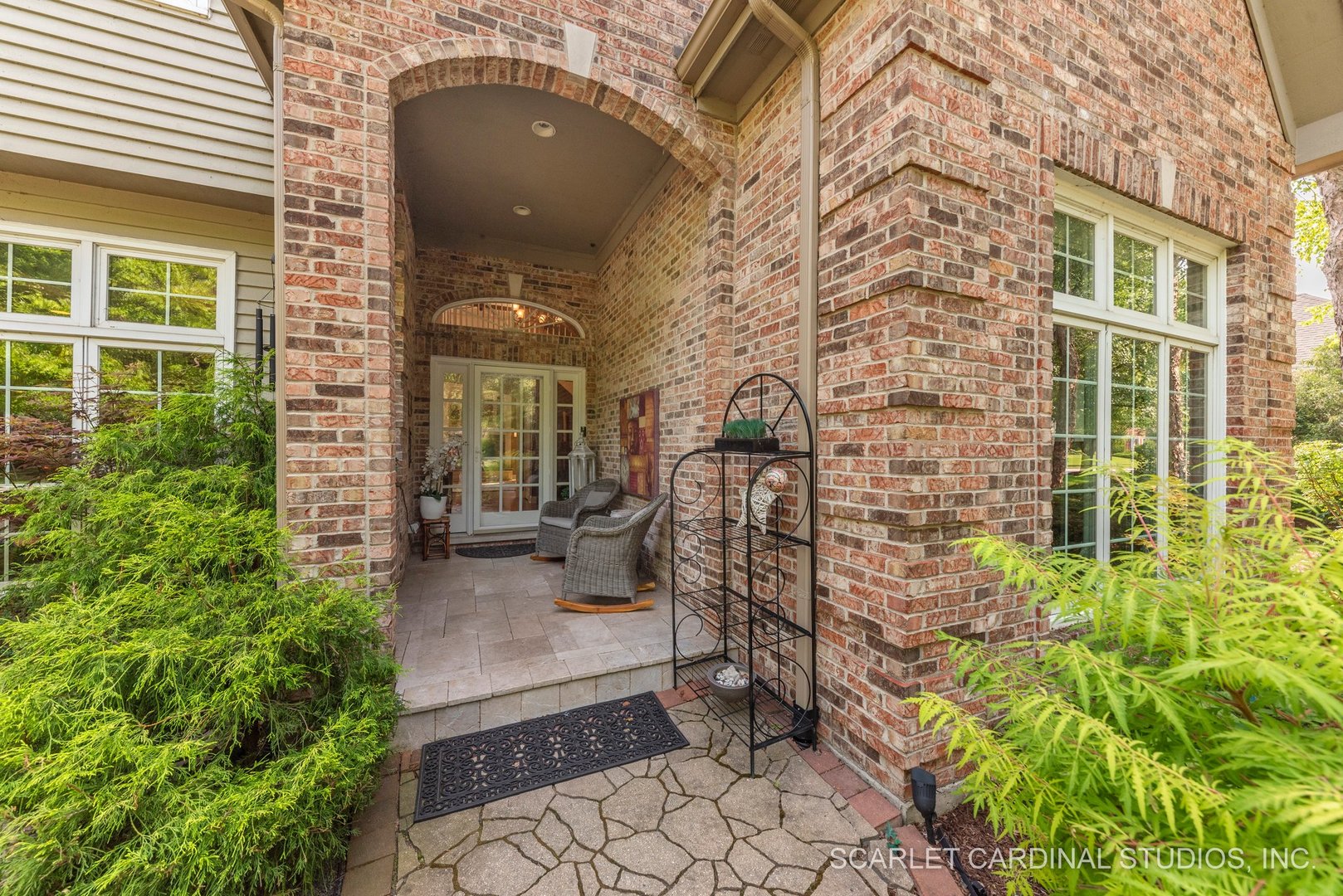 1736 Robert Lane Naperville, IL 60564 - Photo 4 of 82 a brick building with a bench and potted plants