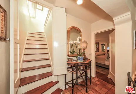 a view of entryway with furniture and wooden floor