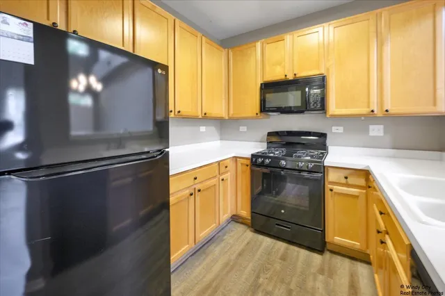 a kitchen with granite countertop a refrigerator stove and microwave