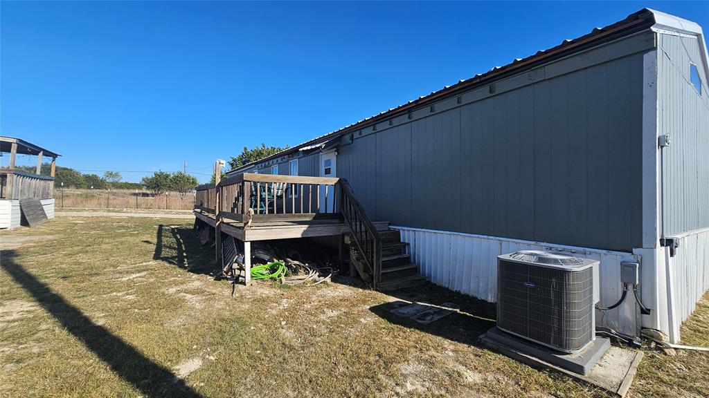 413 Lakeview Trail Weatherford, TX 76087 - Photo 11 of 40 a backyard of a house with wooden deck and furniture