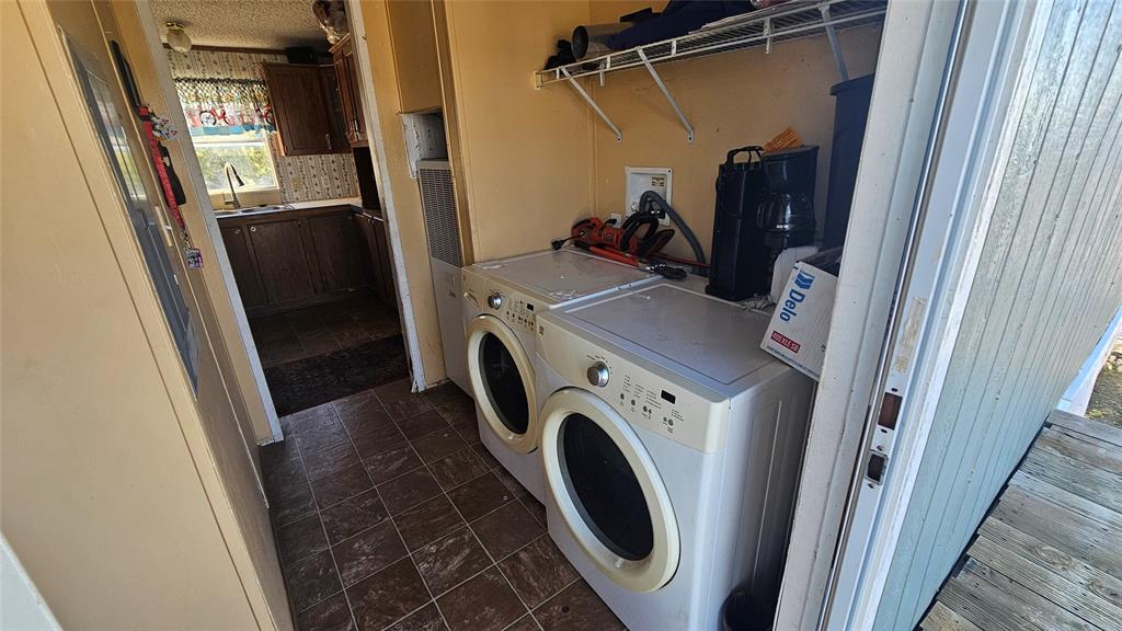 413 Lakeview Trail Weatherford, TX 76087 - Photo 13 of 40 a view of storage and utility room with washer and dryer