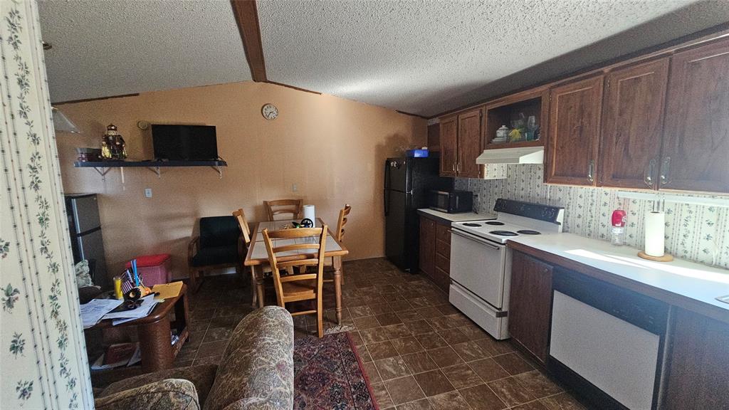 413 Lakeview Trail Weatherford, TX 76087 - Photo 15 of 40 a kitchen with granite countertop a sink stove and cabinets