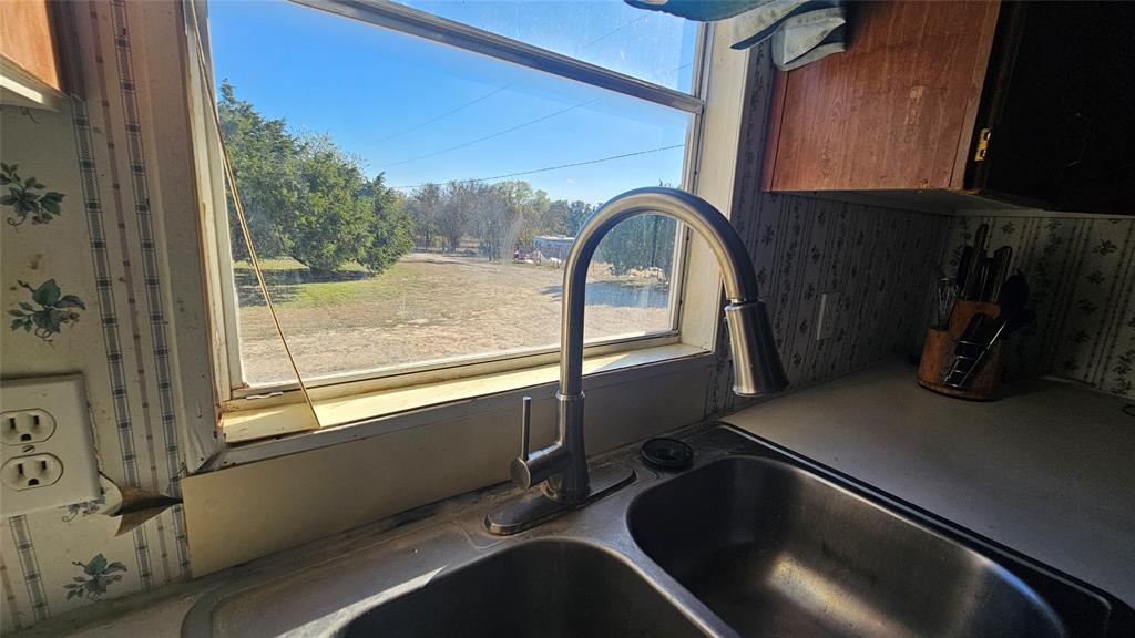 413 Lakeview Trail Weatherford, TX 76087 - Photo 16 of 40 a view of a room with a sink and dishwasher