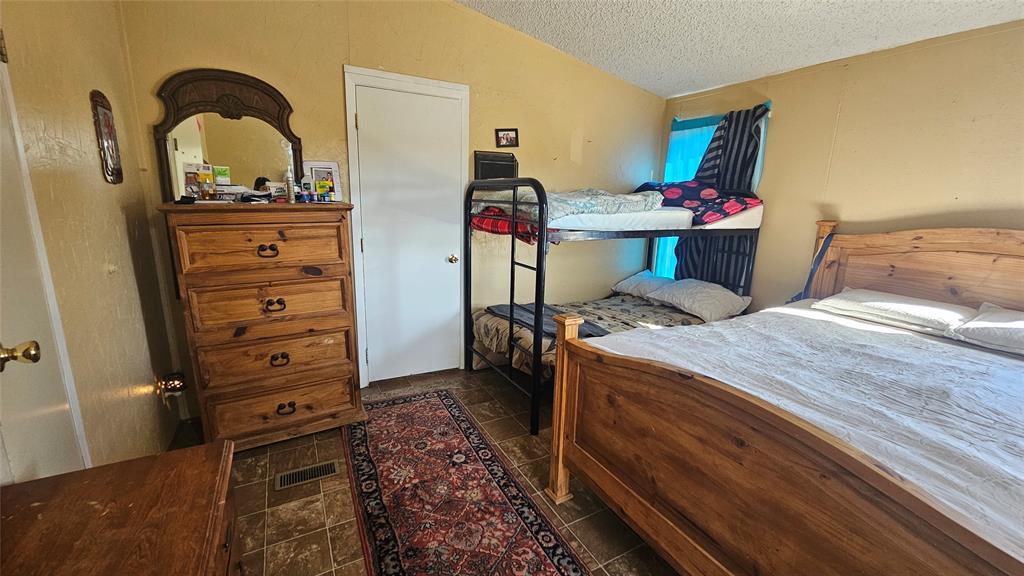 413 Lakeview Trail Weatherford, TX 76087 - Photo 19 of 40 a bed room with a bed and a dresser