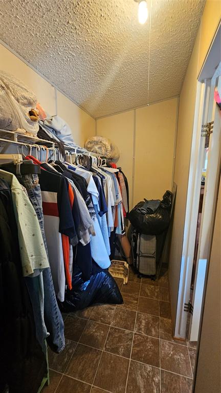 413 Lakeview Trail Weatherford, TX 76087 - Photo 20 of 40 a view of walk in closet with clothes and shoes