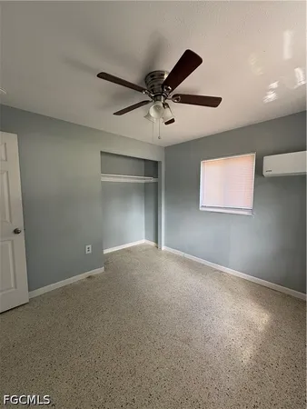 a view of a livingroom with a ceiling fan and window
