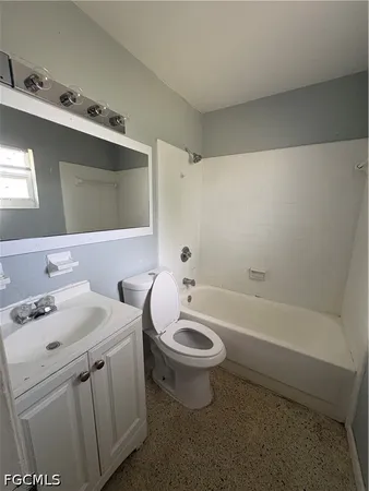 a bathroom with a sink a toilet and bathtub