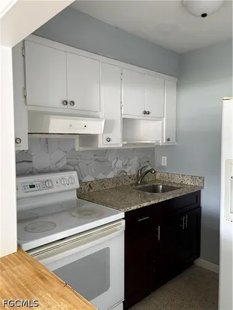 a view of a kitchen with sink and cabinets